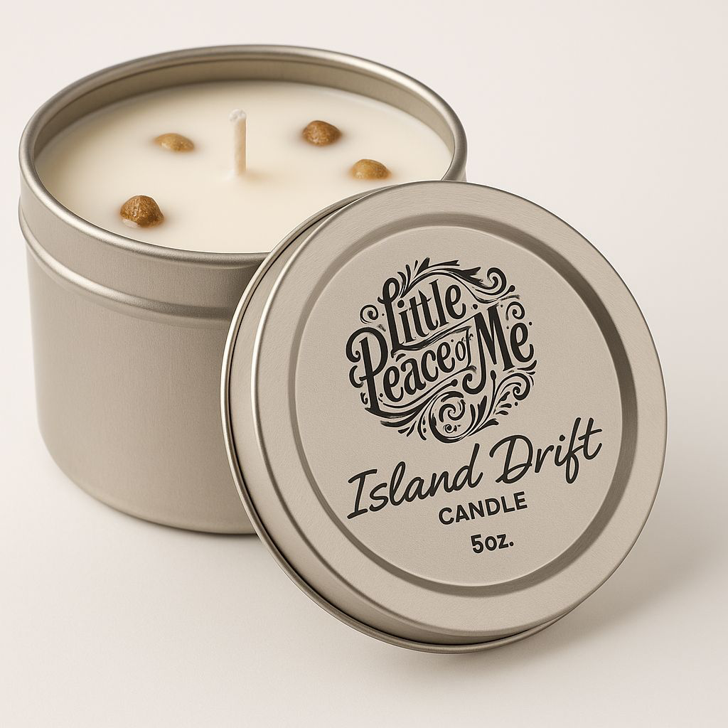 I zoomed in picture of a 5 oz tin can holding wax with some stones in the wax lid laying in front that reads the logo Little piece of Me Island drift candle it's on a white backdrop with a light shadow