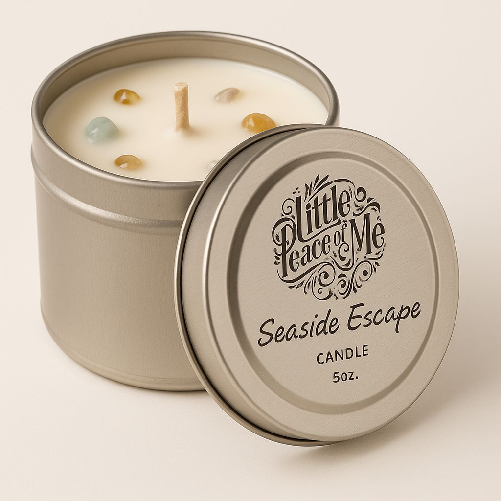 Zoomed in picture of a tin wax candle with a lid leaning against it that reads the logo a little piece of me Seaside escapes candle on a white backdrop with a light shadow